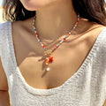 Collar de abalorios blanco con charm de pez cerámico, estrella de mar y perla, cierre OT dorado